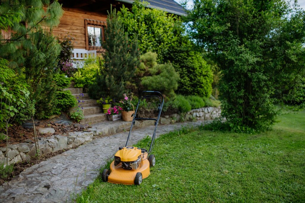 Lawn mower in the garden, garden work concept.